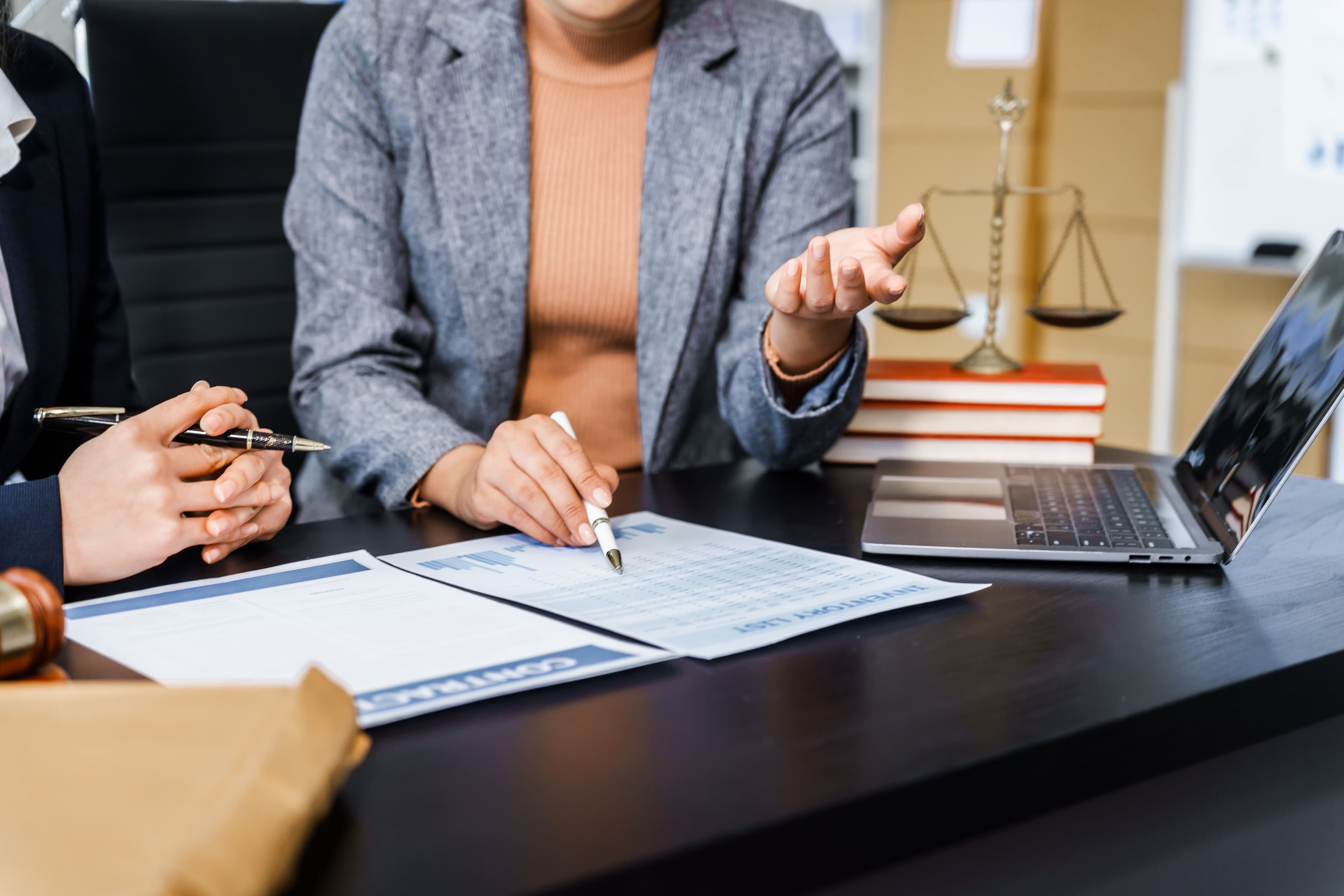 A Harter & Schottland attorney reviewing a business contract with a client, ensuring every clause protects their interests before signing.